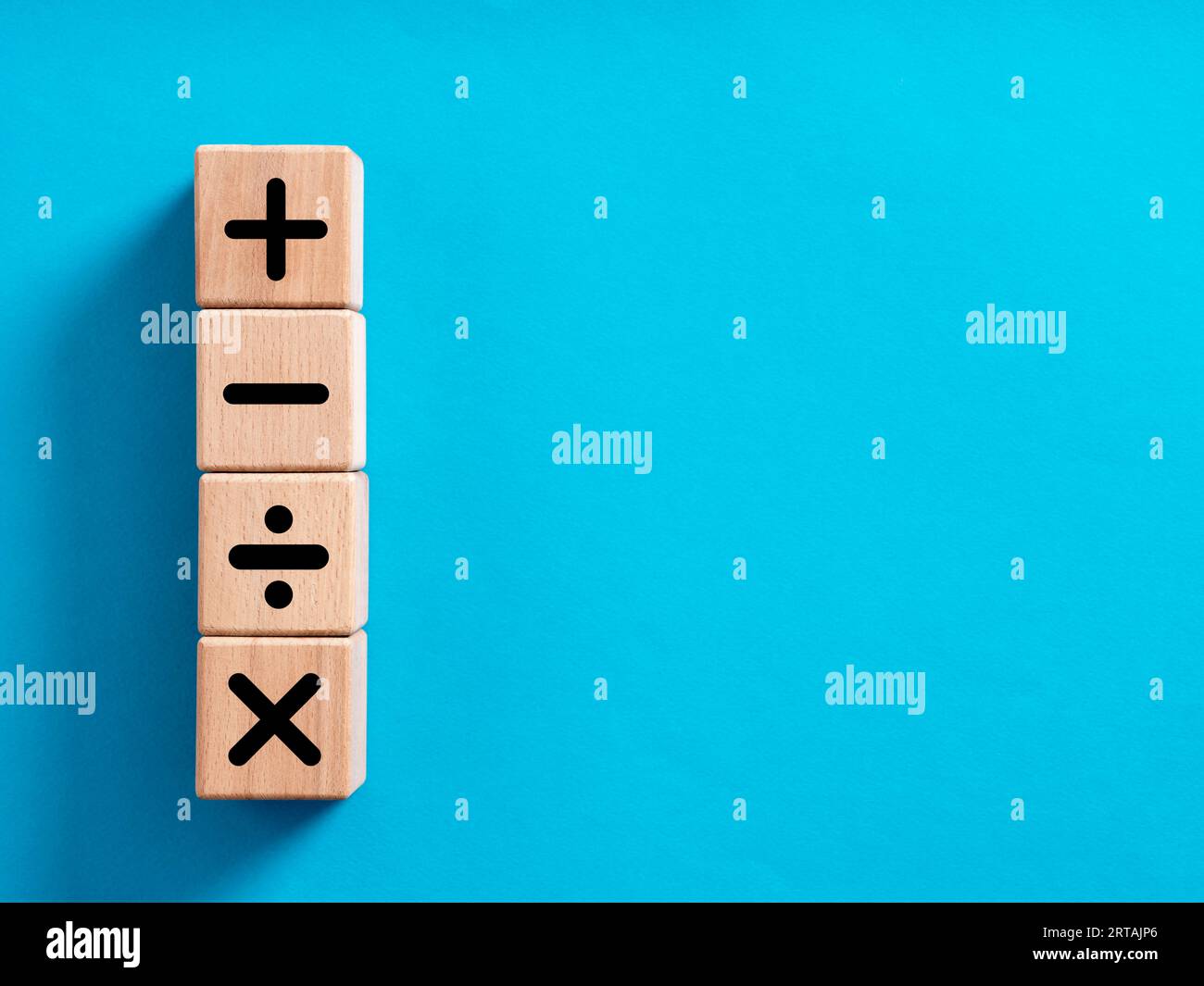 Basic mathematical operations symbols. Plus, minus, multiply and divide symbols on wooden cubes. Mathematic or math education and basic calculations f Stock Photo