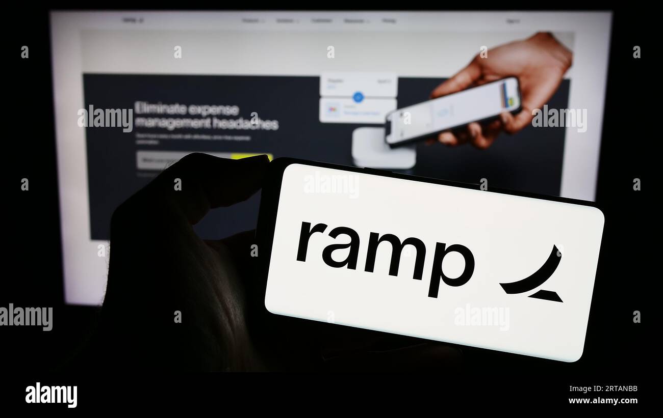 Person holding mobile phone with logo of US software company Ramp