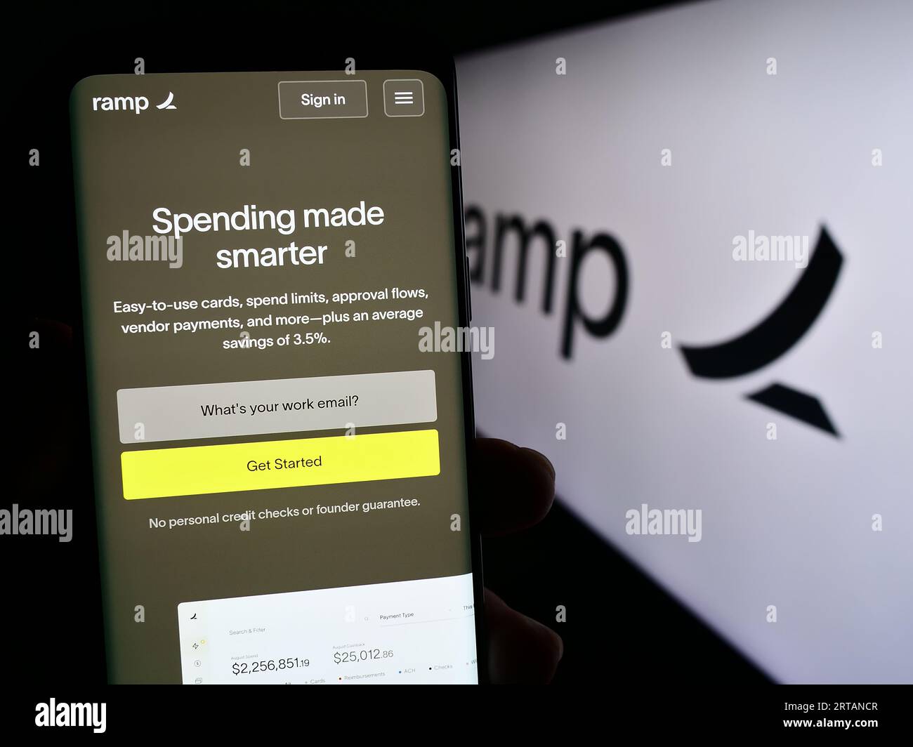 Person holding cellphone with web page of US software company Ramp