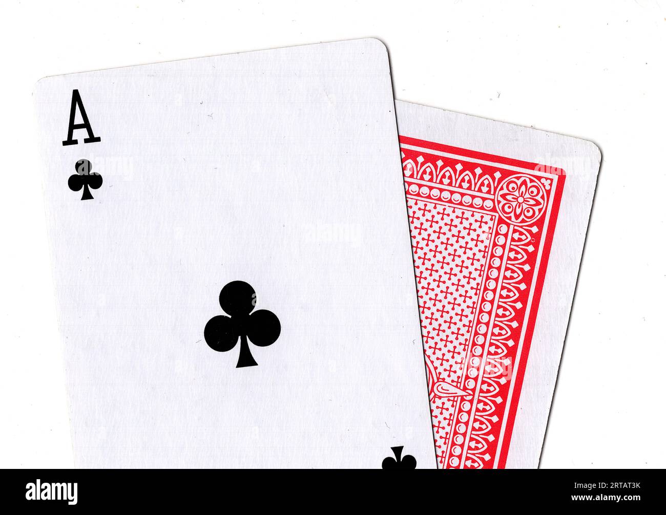 A pair of vintage playing cards revealing an ace of clubs on a white