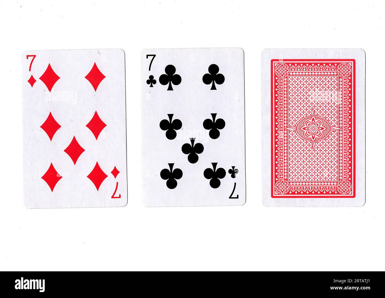 A hand of three playing cards revealing two sevens on a white