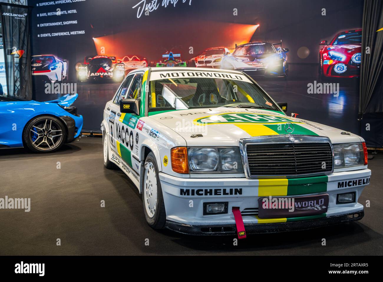 Mercedes-Benz 190E on a stand advertising the Motorworld event at IAA Mobility 2023, Munich Germany. Stock Photo
