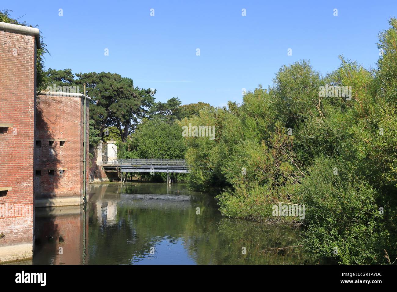 Fort Brockhurst, Gosport, Hampshire, England. September 10th 2023. Gosport Heritage Open Day. The fort was built between 1858 and 1862. View of part of the moat with part of the fort exterior walls, trees and a small bridge. Stock Photo