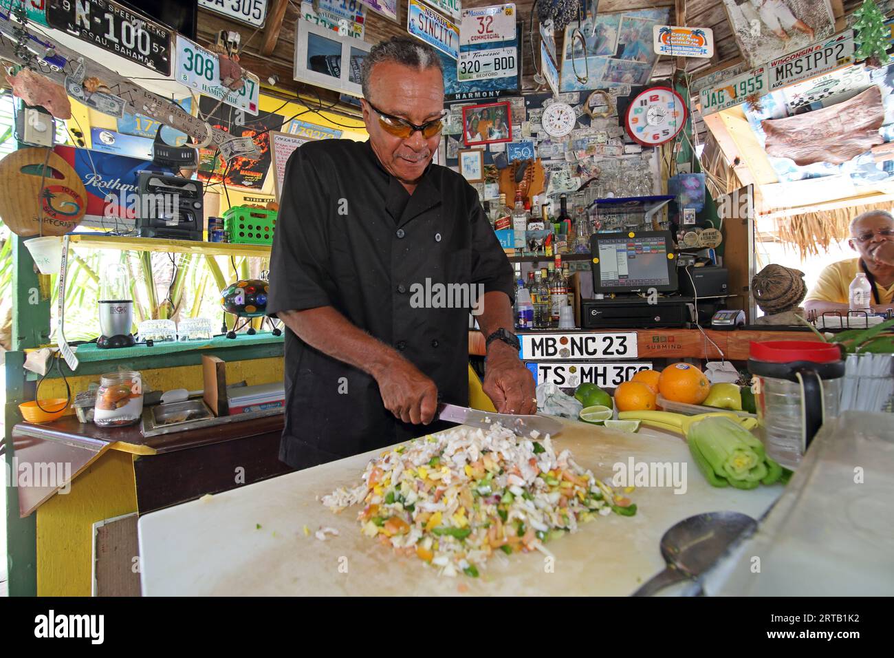 Preparing a Conch Salad at Max Conch Bar, Deadman's Cay Settlement, Long Island, The Bahamas Stock Photo