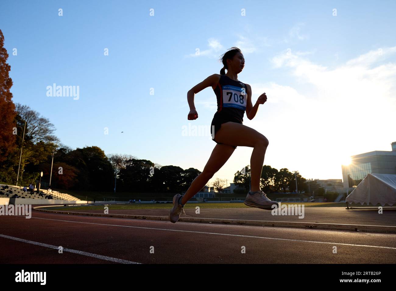 Japanese athlete running on track Stock Photo