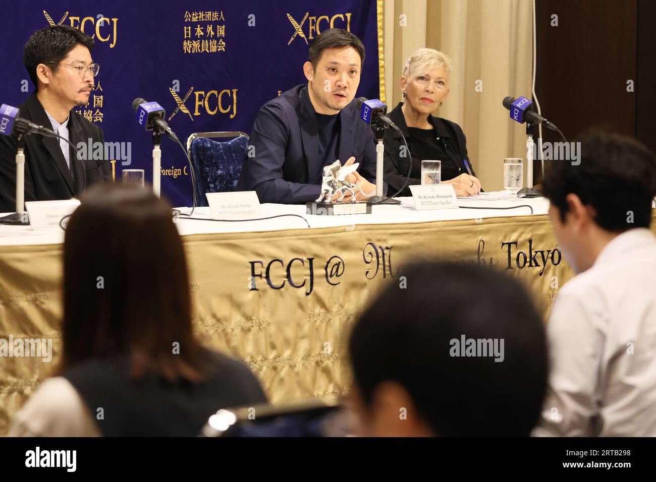 Tokyo, Japan. 12th Sep, 2023. Japanese film director Ryusuke Hamaguchi (C) speaks at a press