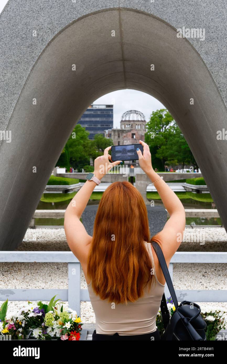 An American woman seen taking a photograph at the Atomic Bomb Dome in ...