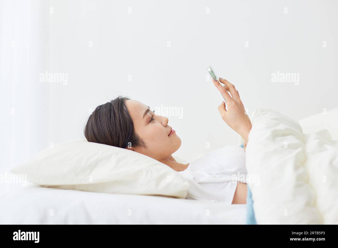 Young Japanese woman using smartphone Stock Photo