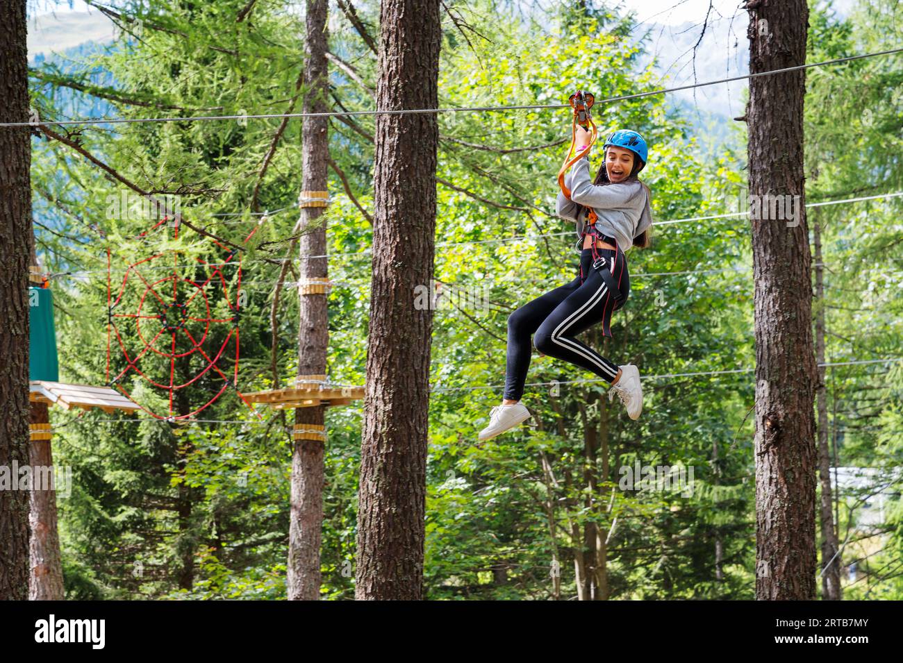Side view of excited young female with opened mouth looking down while ...
