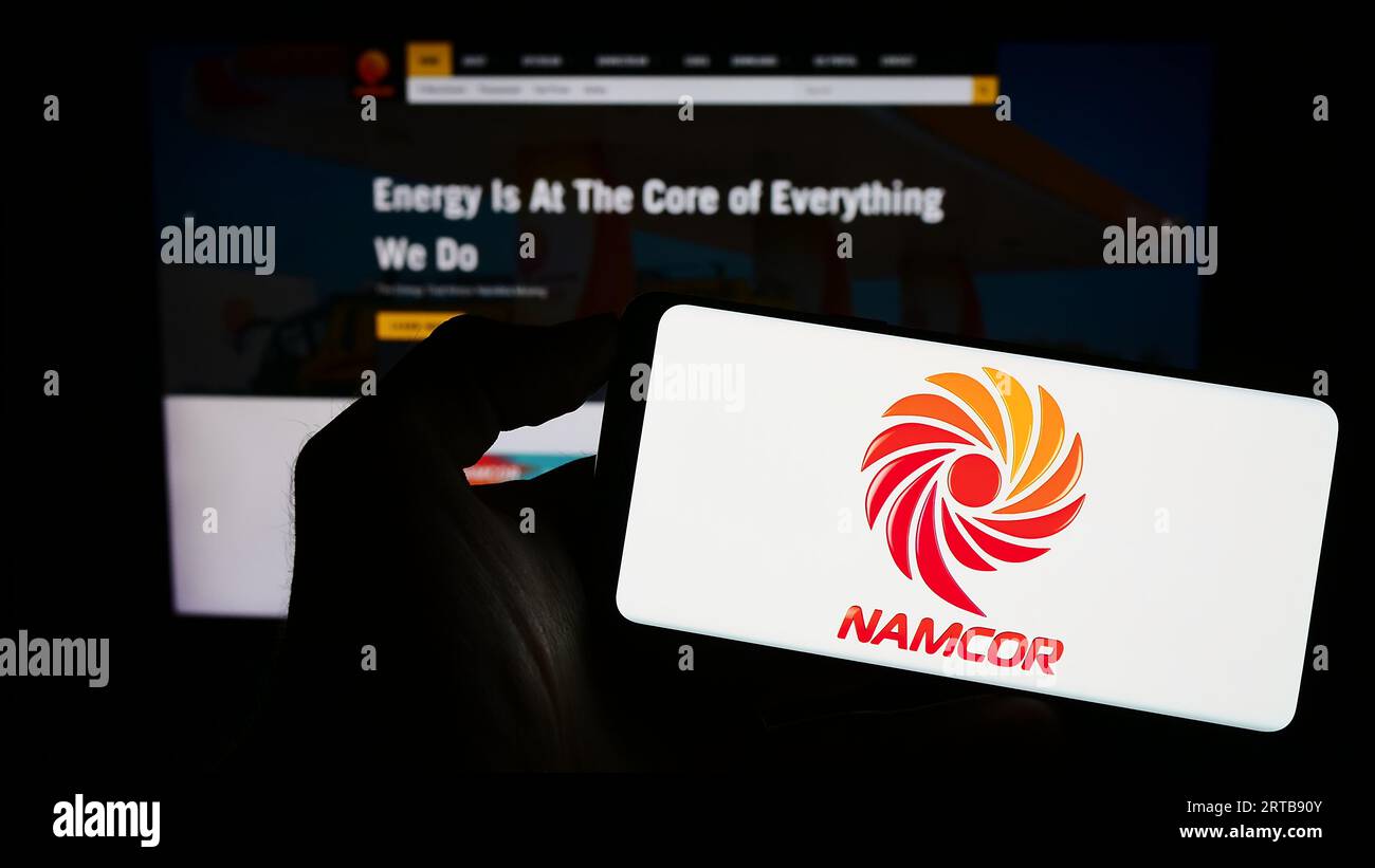 Person holding mobile phone with logo of national petroleum corporation
