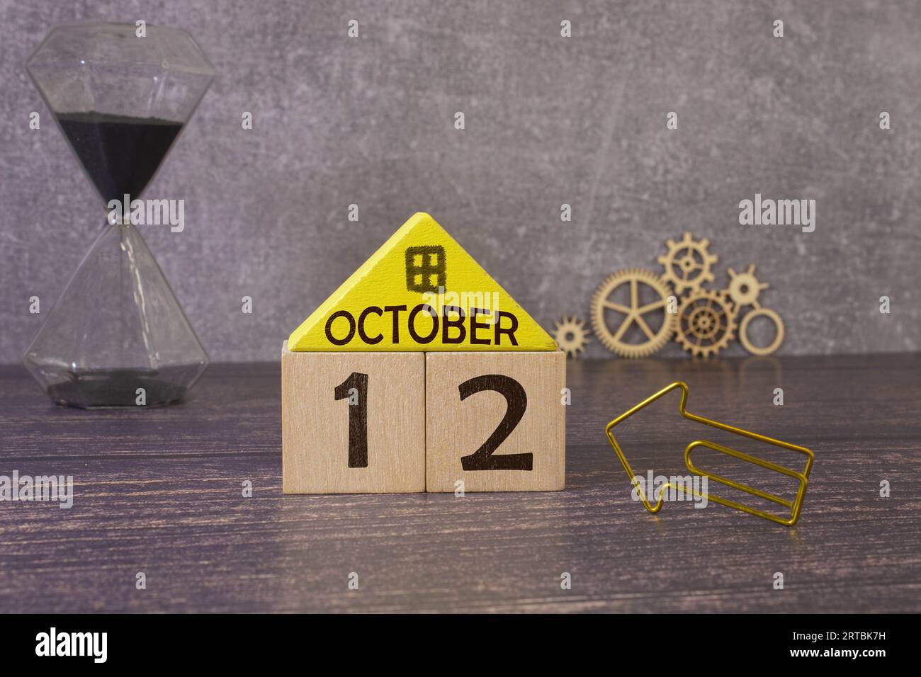 October 12th. Hello October, Cube wooden calendar showing date on 12 October, Wooden calendar with blur objects on background. Stock Photo