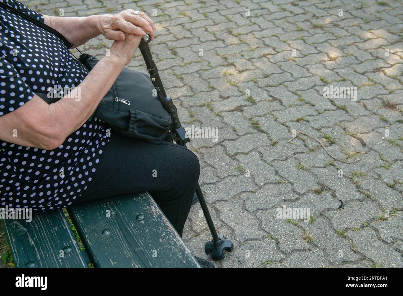 elderly person with cane, without legs and cane due to old age, walking