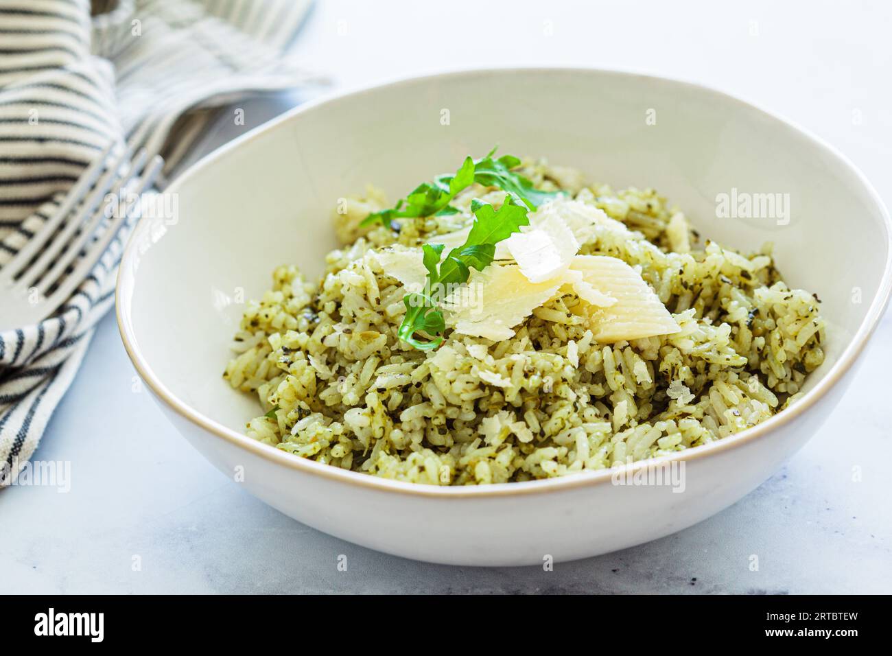 Green pesto risotto with parmisan, white marble background Stock Photo