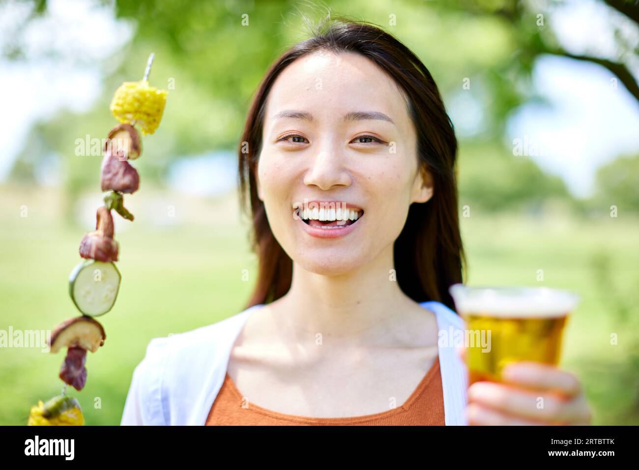 Japanese woman having barbecue at city park Stock Photo - Alamy