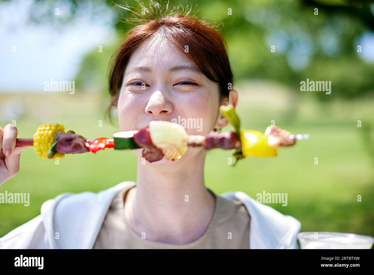 Japanese woman having barbecue at city park Stock Photo - Alamy