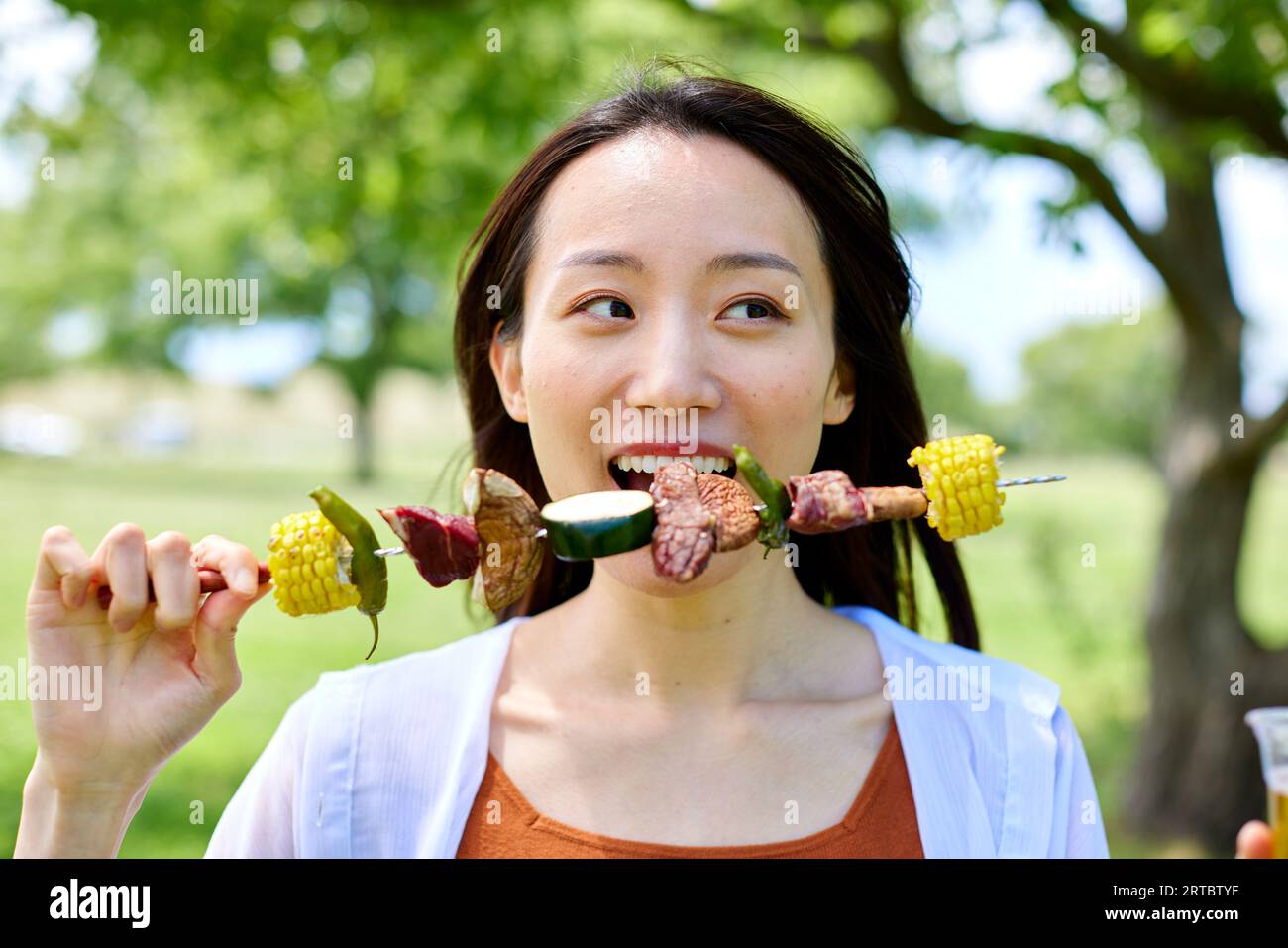Japanese woman having barbecue at city park Stock Photo - Alamy