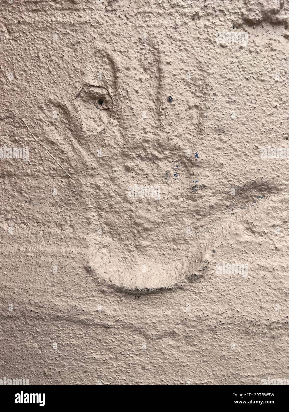 Urban Archaeology: Hand impression in a wall. Stock Photo