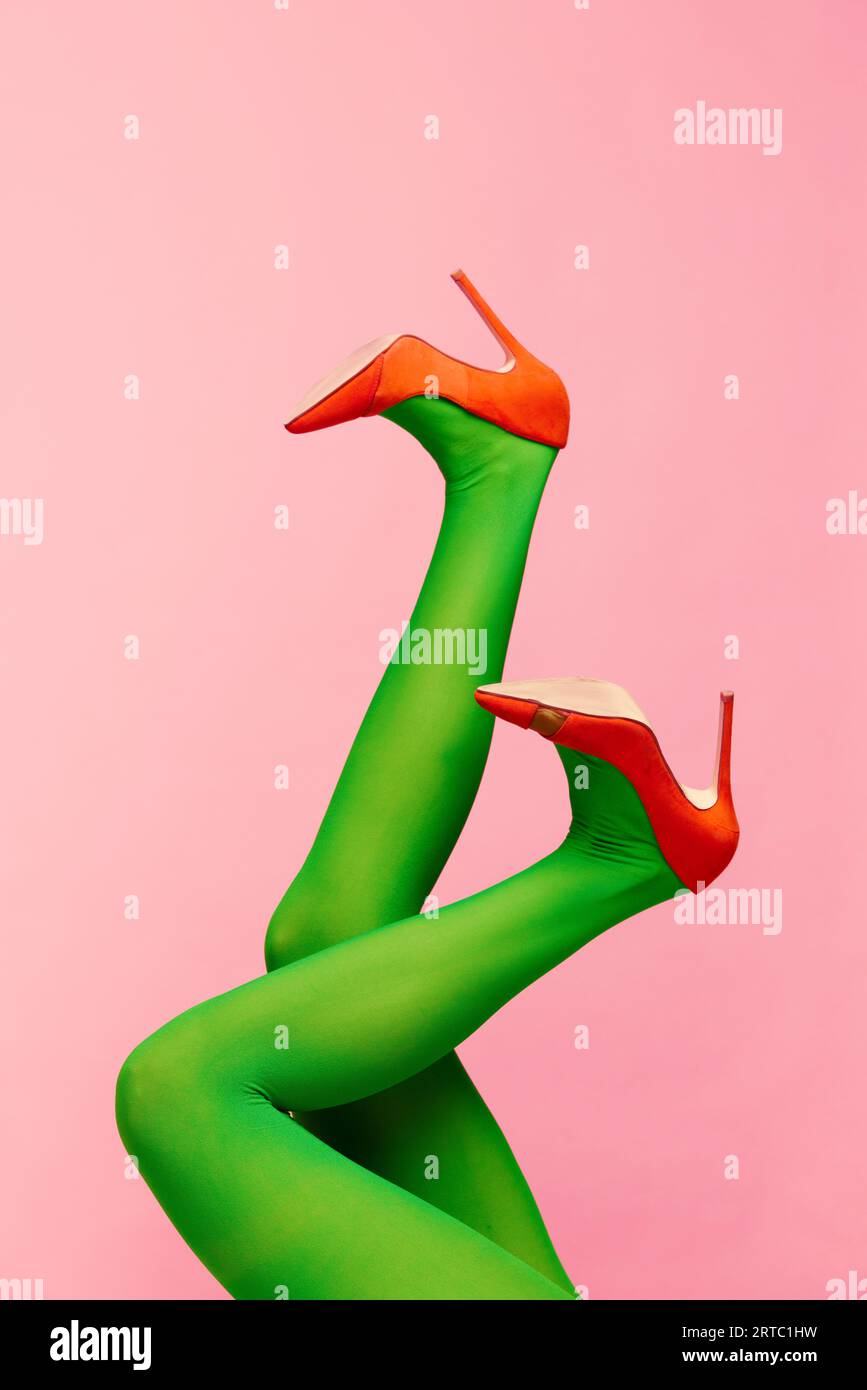 Color Legs Matching colors. Slender female legs in green tights and orange heeled ...