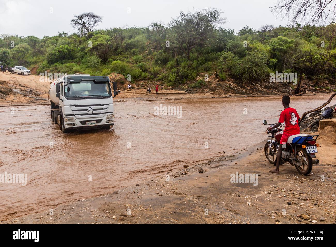 OMO VALLEY, ETHIOPIA - FEBRUARY 4, 2020: Truck stuck in swollen waters of Kizo river, Ethiopia Stock Photo