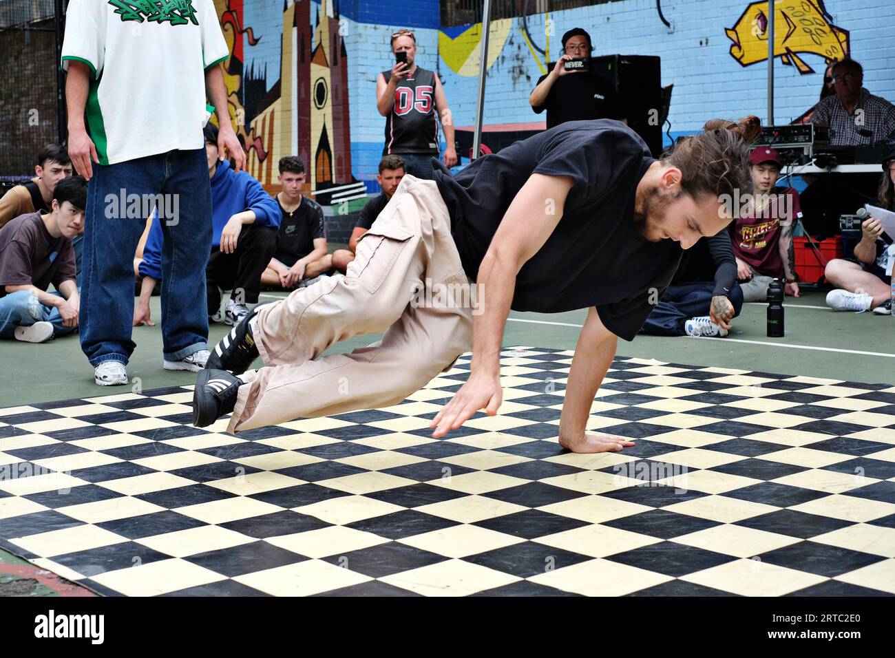 A breakdancing 'Floats' horizontal, with both legs and one arm off the
