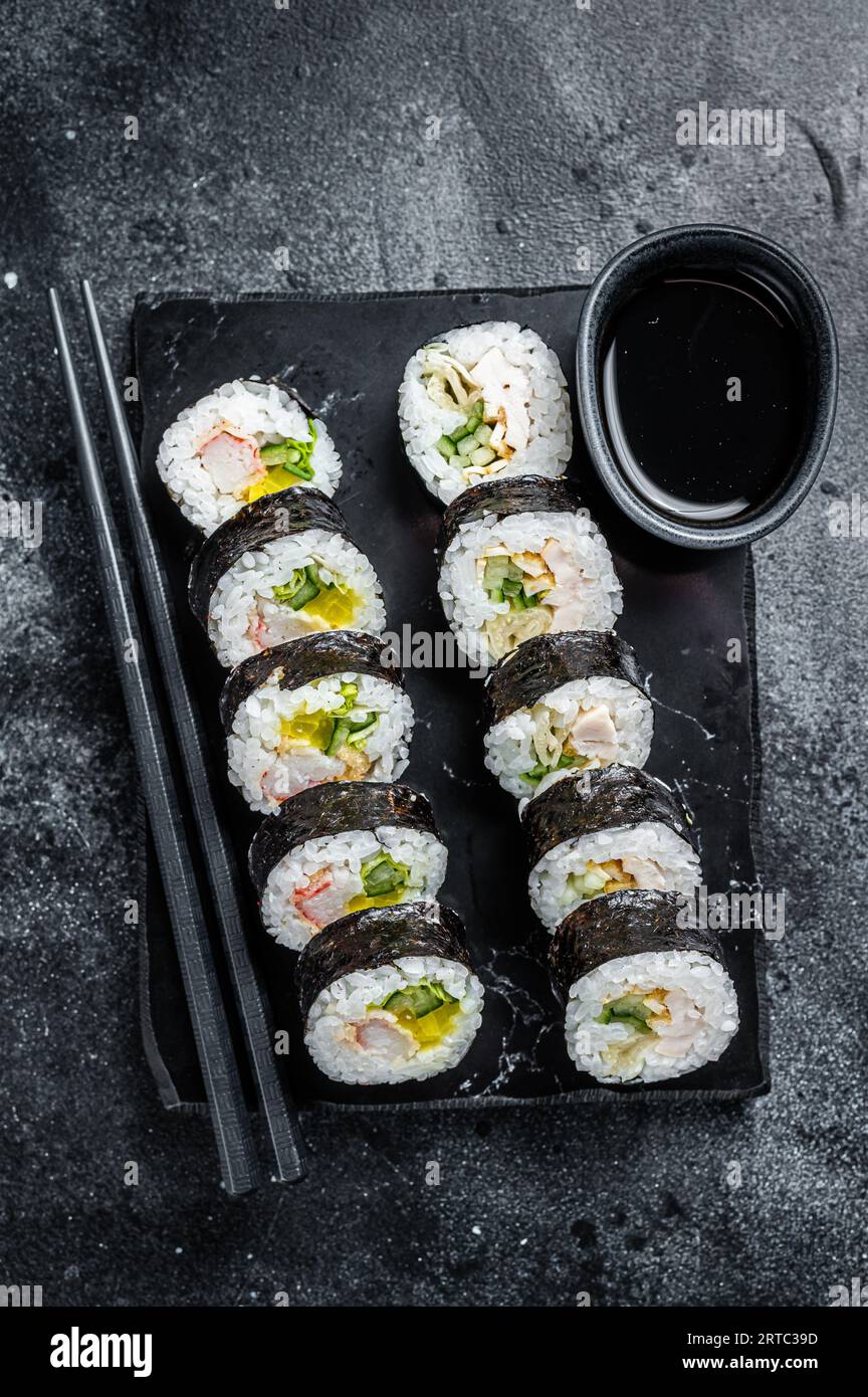 Korean rice roll Kimbap or gimbap, Korean sushi. Black background. Top view. Stock Photo
