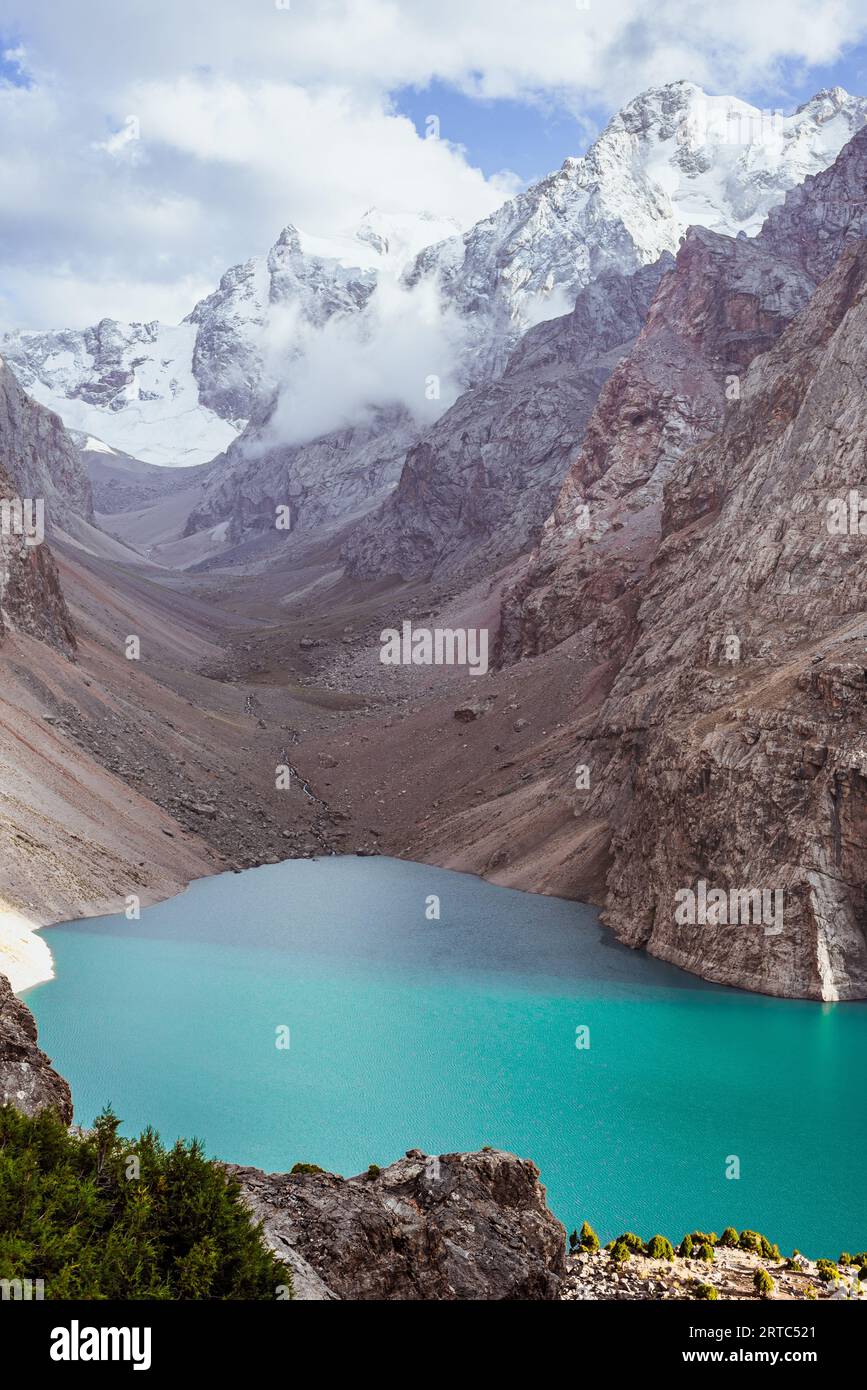 Mountain lake with crystal blue water and snowy peaks Stock Photo - Alamy