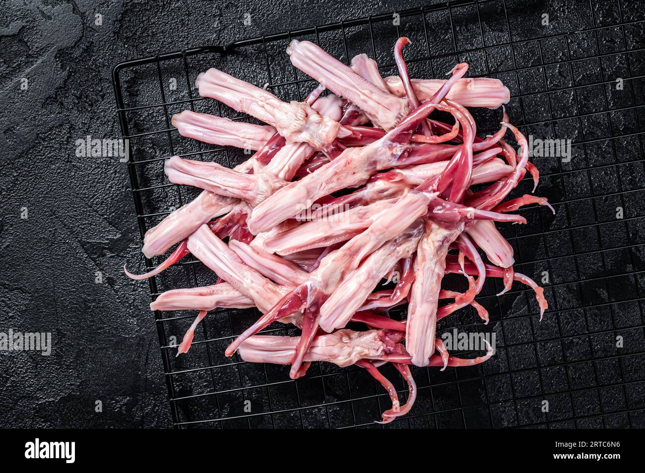 Raw Duck Tongue ready for cooking. Black background. Top view Stock