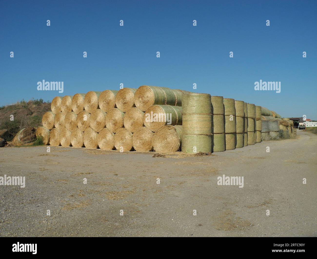 Austria, stacked straw bales used as bedding and fodder for cattle