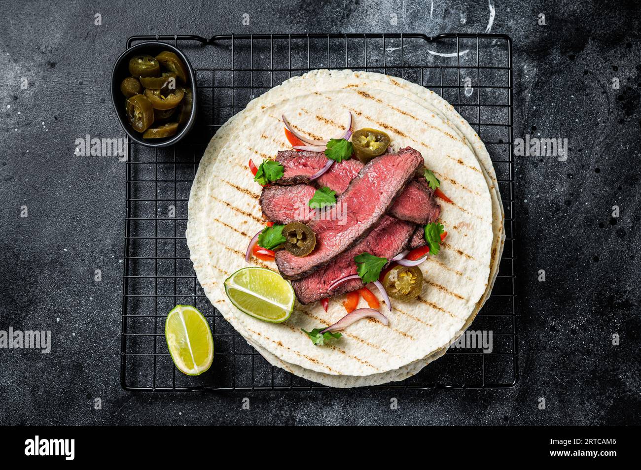 Grilled Beef steak Fajitas, taco tortillas with onion, jalapeno and