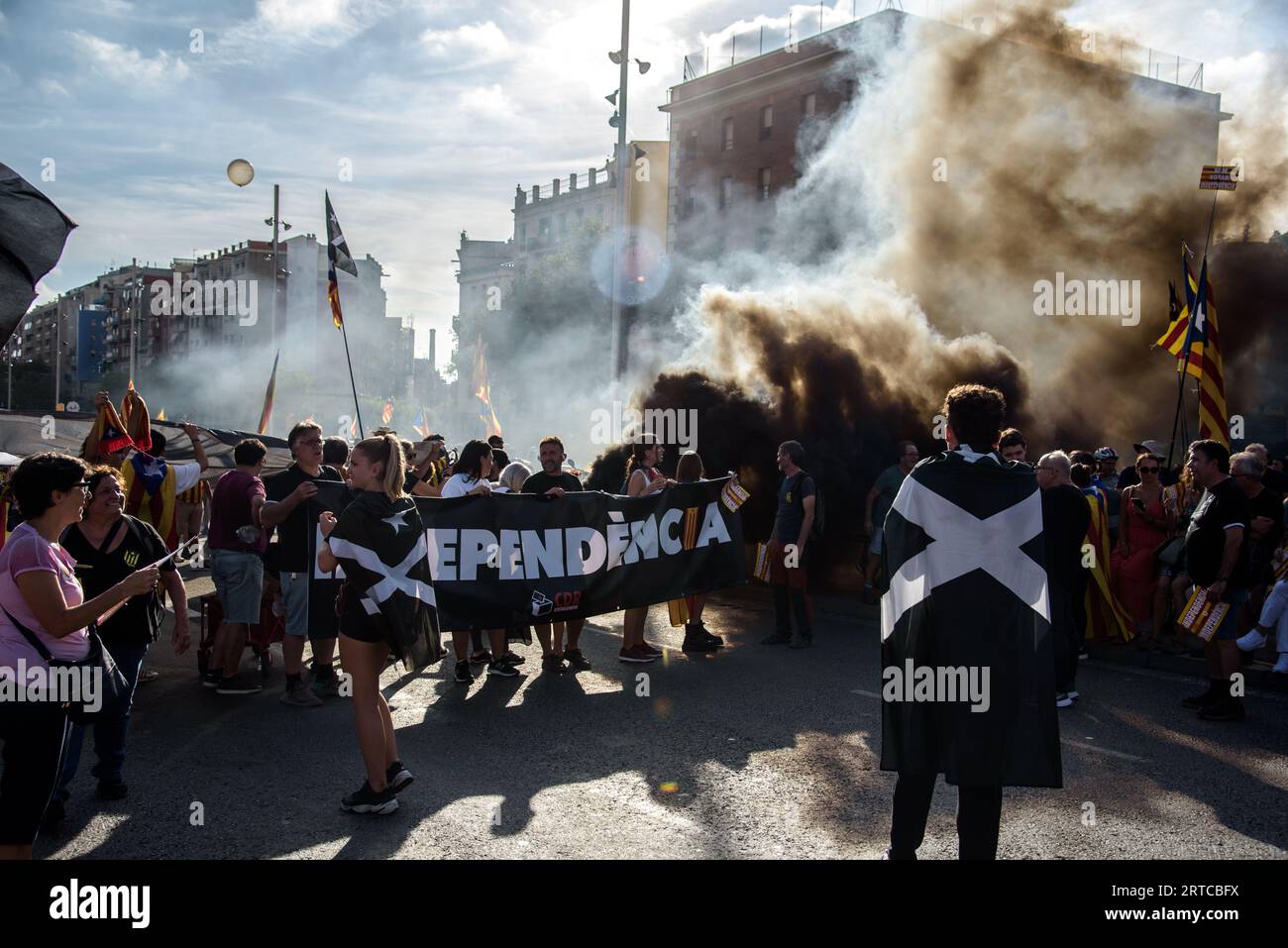 Barcelona, Catalonia, Spain - September 11, 2023: Group of radical independentists burn a black smoke bomb during the National Day of Catalonia demons Stock Photo