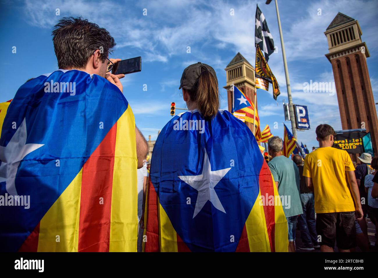 Barcelona, Catalonia, Spain - September 11, 2023: Young participants in the National Day of Catalonia demonstration wrapped in the independence flag w Stock Photo