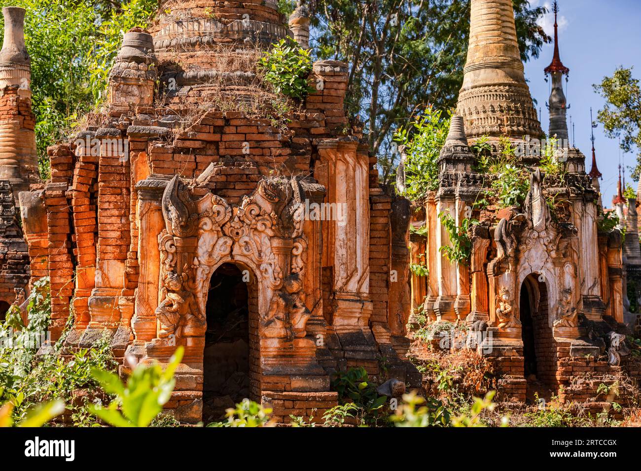 Pagodas and stupas in the Buddhist cemetery of the impressive In-Dein Pagoda Forest on Inle Lake in Myanmar Stock Photo