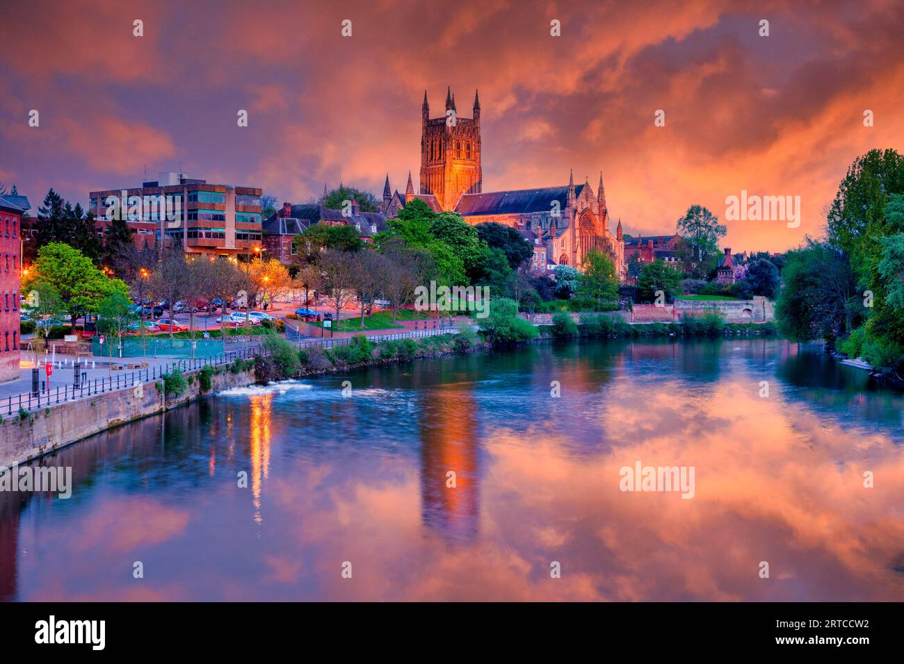 Worcester Cathedral illuminated at twilight with sunset sky and reflection in River Severn Stock Photo