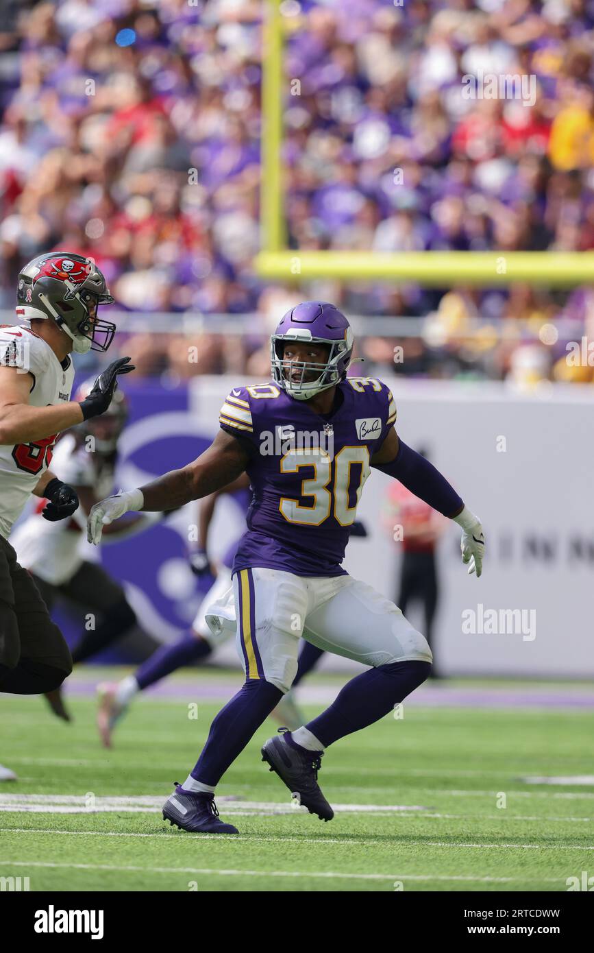 Minnesota Vikings fullback C.J. Ham (30) runs with the ball during the  first half of an NFL football game against the Chicago Bears, Sunday, Jan.  8, 2023, in Chicago. (AP Photo/Kamil Krzaczynski