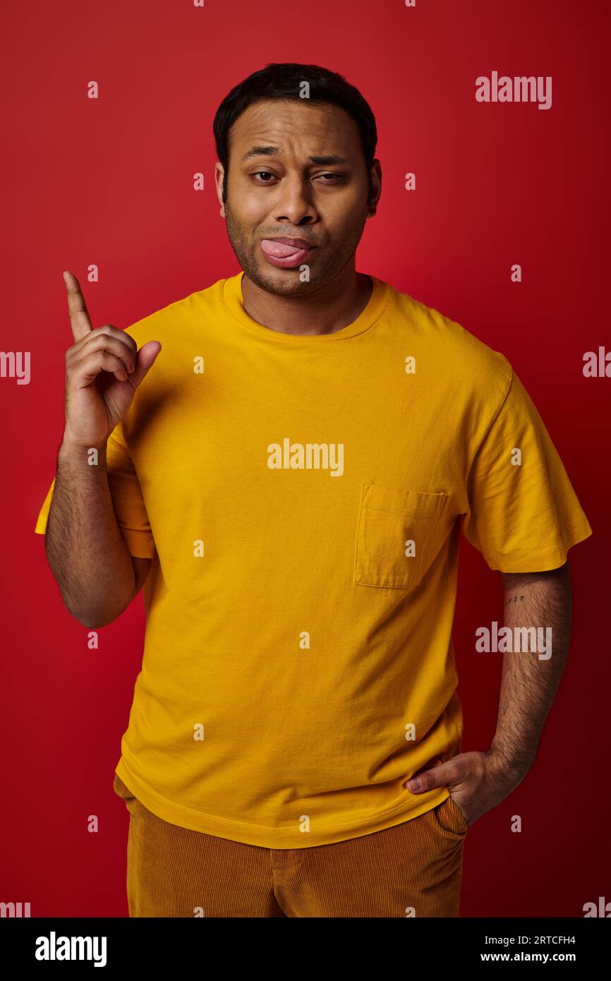 face expression, emotional man sticking out tongue and pointing up on