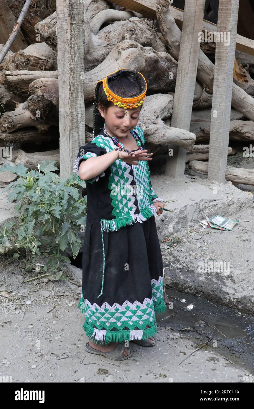 Young Kalash girl with henna artwork on her hand for the summer festival Stock Photo