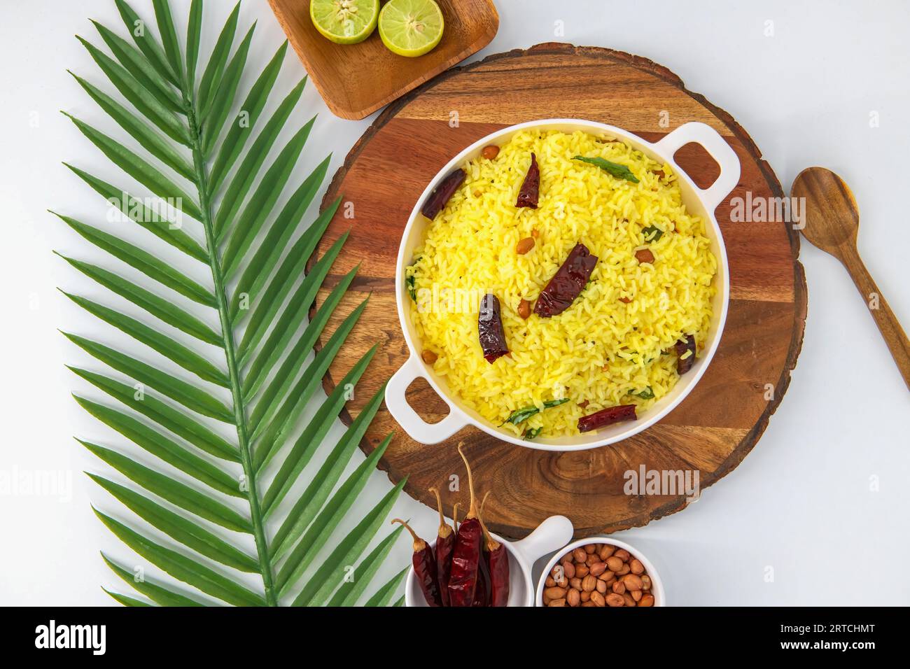 Fresh, delicious and refreshing lemon rice dish for breakfast, lunch and dinner. Famous Indian rice recipe with cooked rice, tempting spices, peanut. Stock Photo