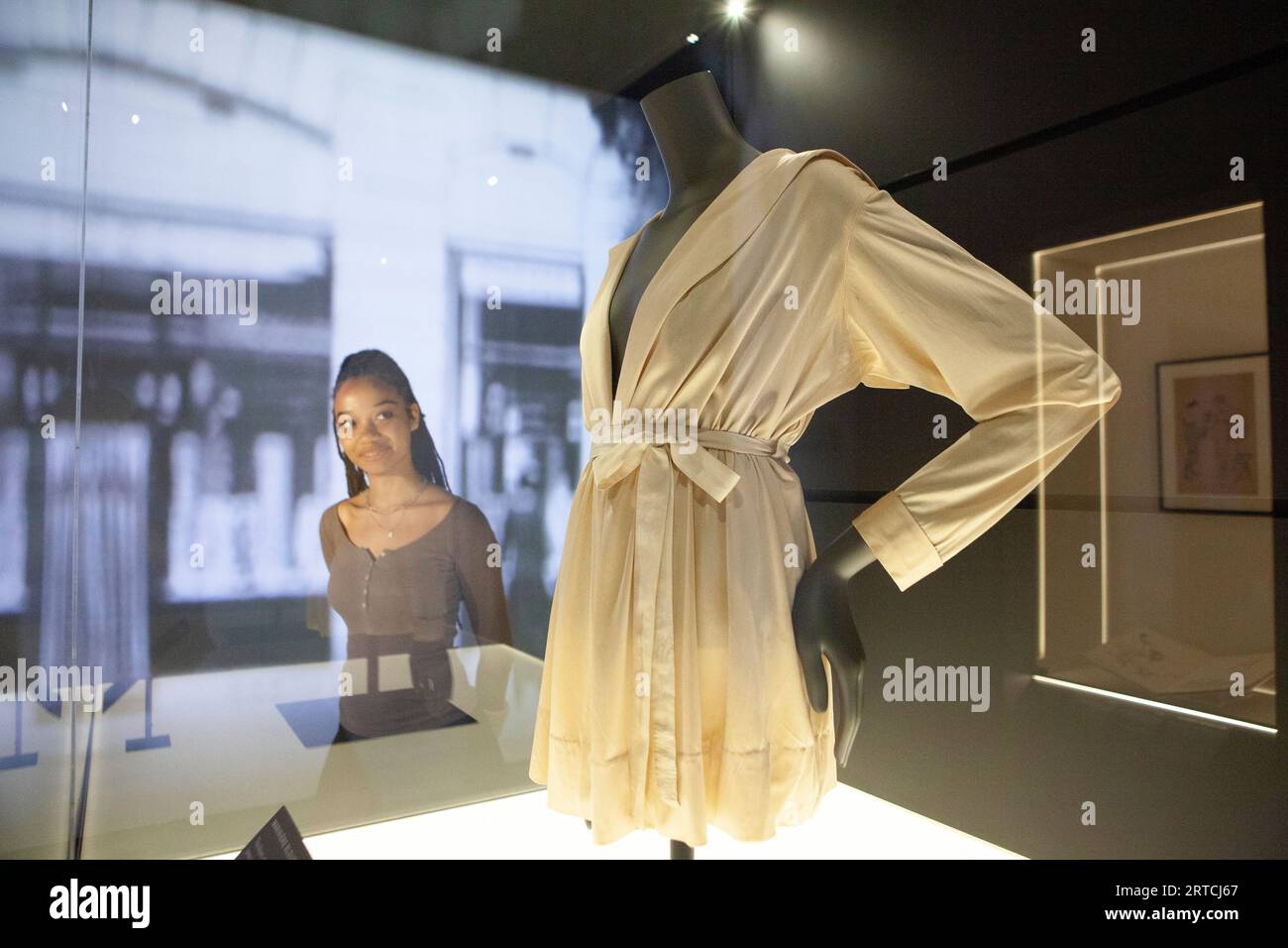 EMBARGO until 1 minute past MIDNIGHT 12 SEPT London, UK. 12th Sep, 2023. A new exhibition, 'Gabrielle Chanel: Fashion Manifesto' opens at V&A, highlighting her connections to British clients, including Queen Elizabeth II. Here a woman looks at a silk jersey Mariniere blouse from 1916, one of Coco Chanel's earliest designs. Credit: Anna Watson/Alamy Live News Stock Photo