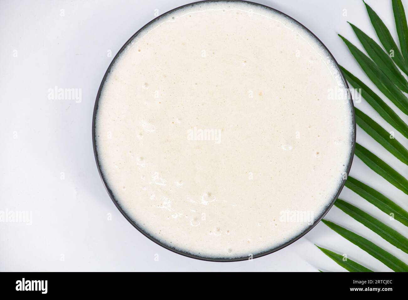 Fermented batter for idli and dosa in an isolated background. Idly and dosa batter in a bowl for fermentation, used to prepare the steamed idly food Stock Photo
