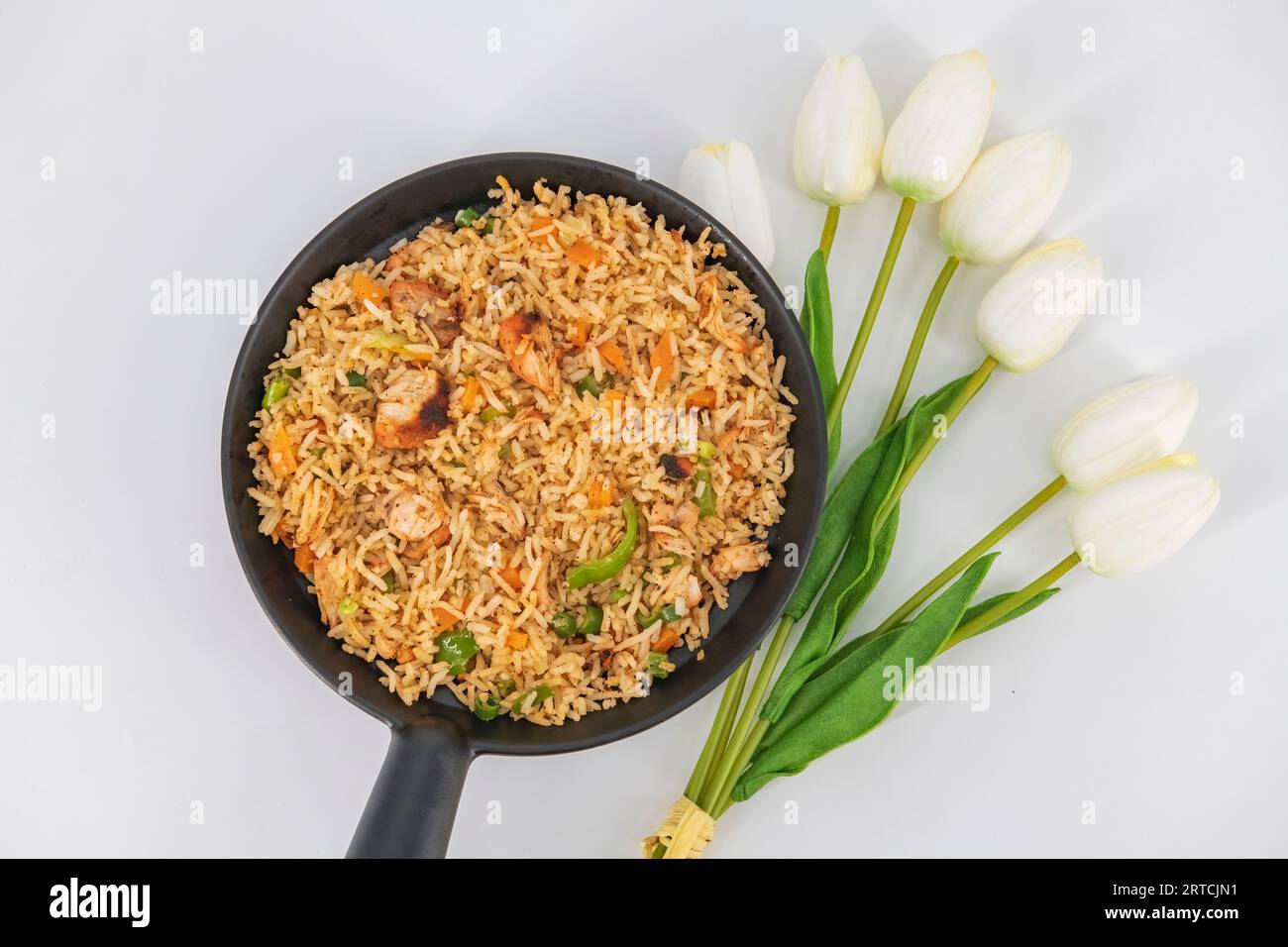 Chicken Fried Rice in black serve bowl isolated on white background