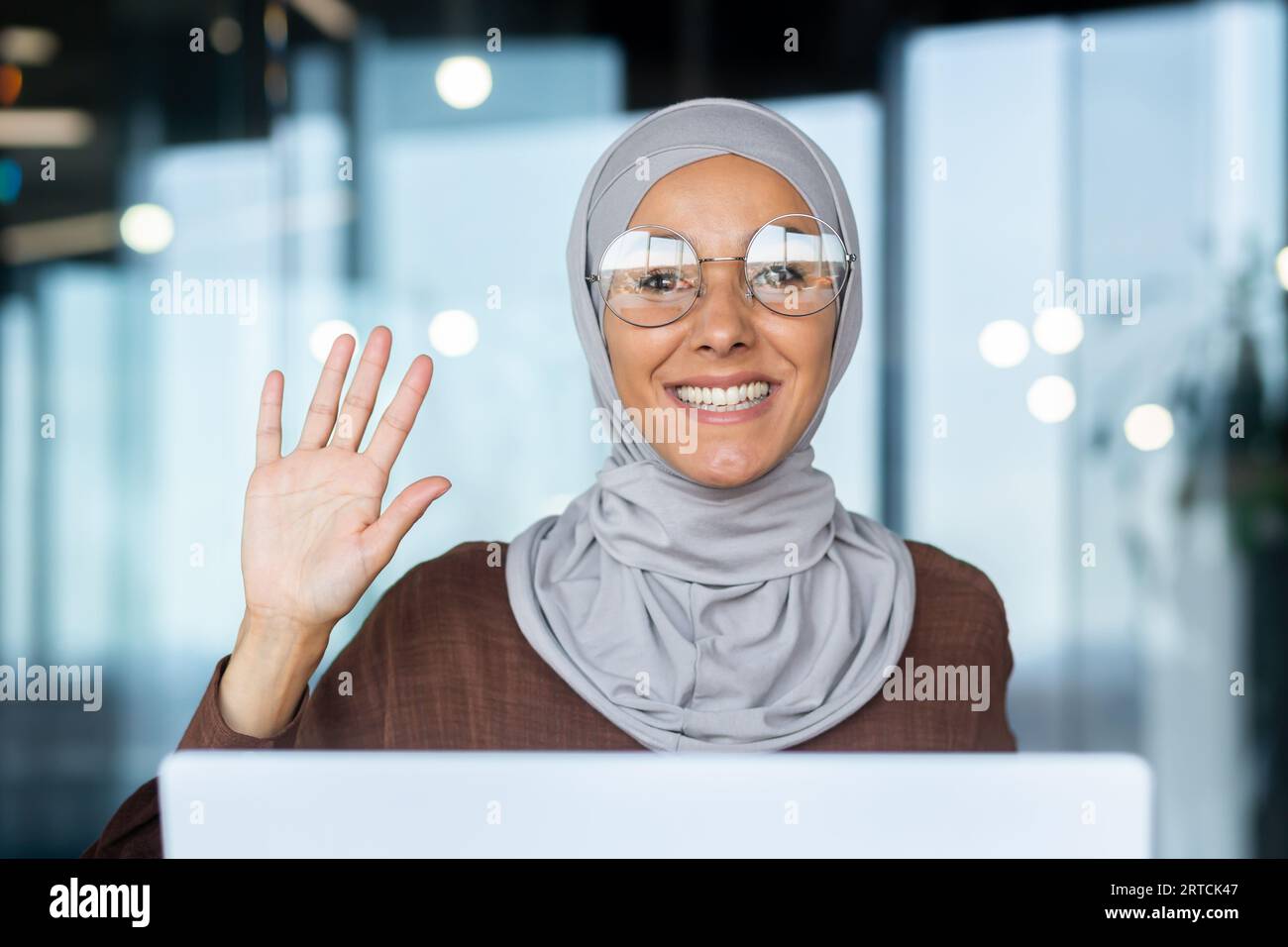 Close-up photo of a portrait of a young Muslim woman in a hijab working ...