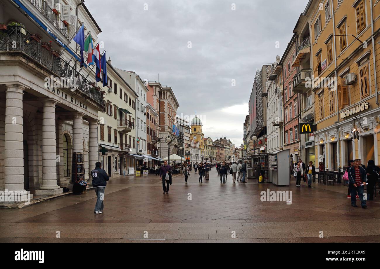 Rijeka, Croatia - October 17, 2014: People Walking at Korzo Street Pedestrian Zone Rainy Fall Day in City Centre. Stock Photo