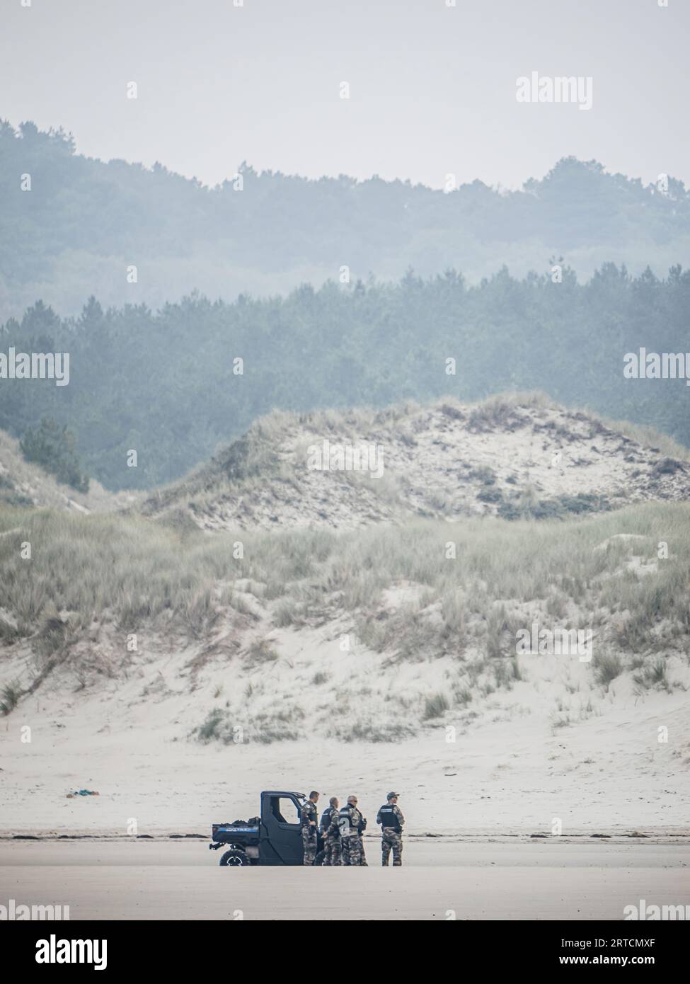 Neufchatel-Hardelot, France - Aug 18, 2023: In Neufchatel-Hardelot, French police officers and gendarmes maintain vigilant surveillance over the dunes and the beach to ensure the illegal migration Stock Photo