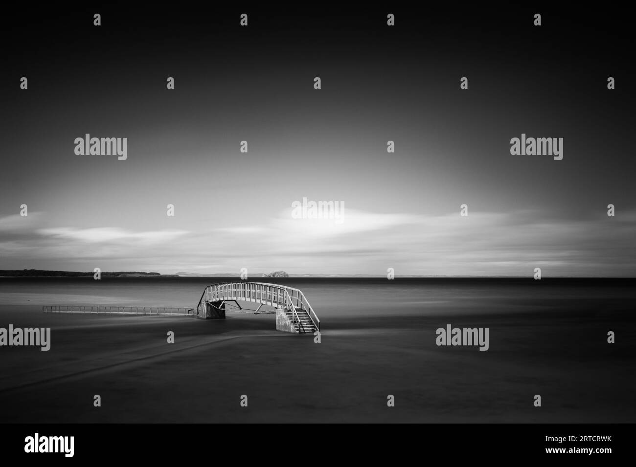 View of a bridge on the beach at high tide, East Lothian, Scotland, UK