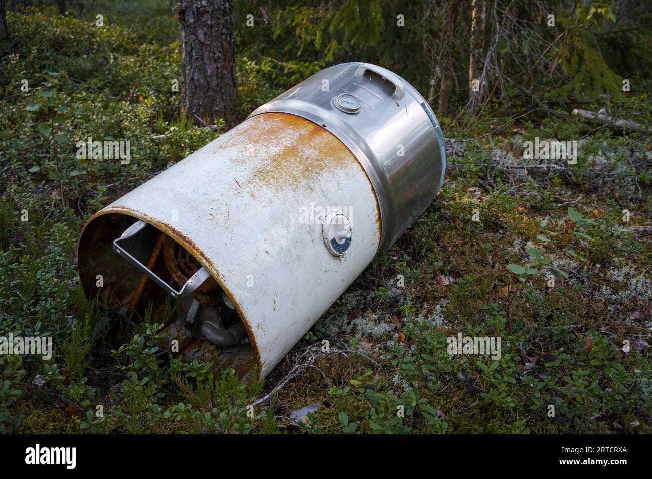 Old 1950's washing machine dumped in the woods Stock Photo
