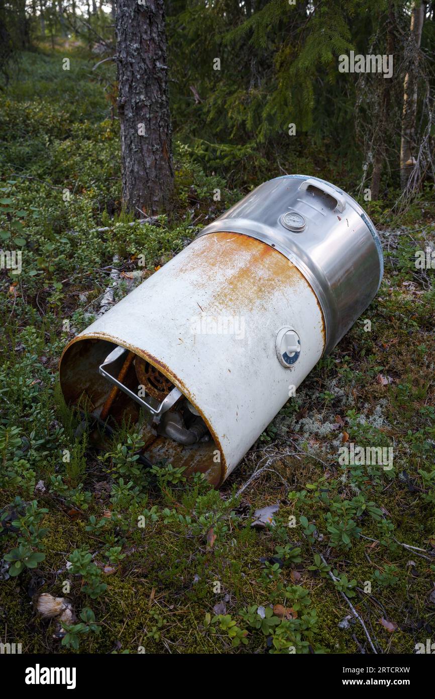 Old 1950's washing machine dumped in the woods Stock Photo