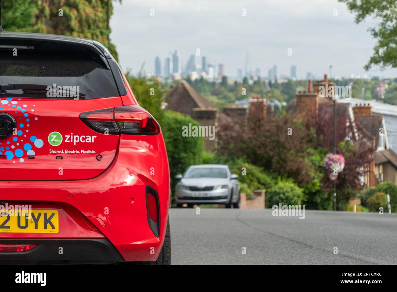 LONDON September 12, 2023 Zipcar parked on street with London skyline
