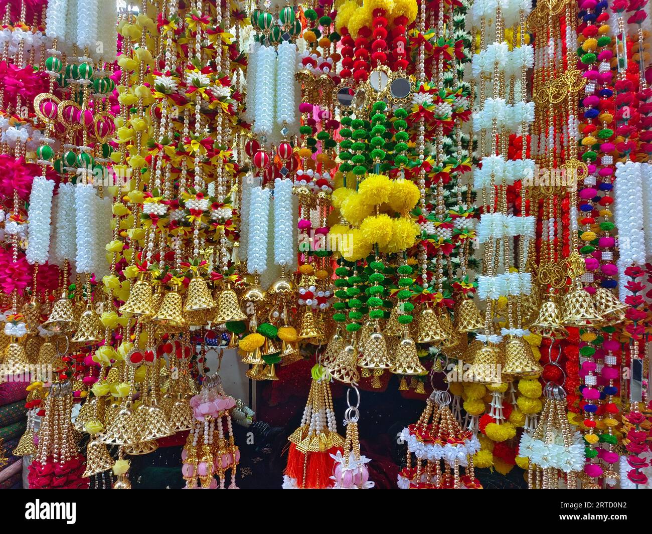 Multicolour artificial flowers used for Diwali festival decoration, hanging inside a shop, on
