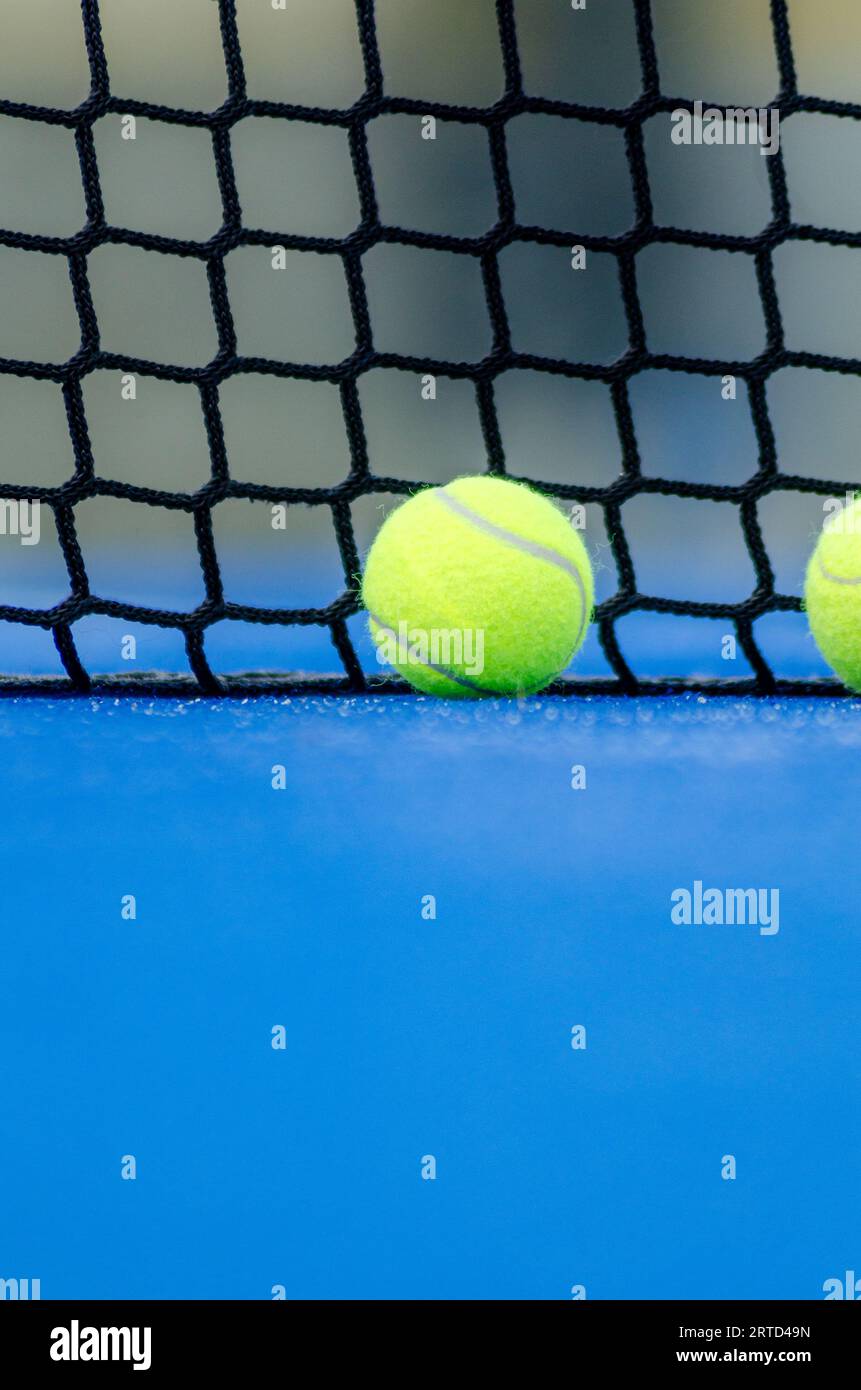 selective focus, two balls near the net in a blue paddle tennis court