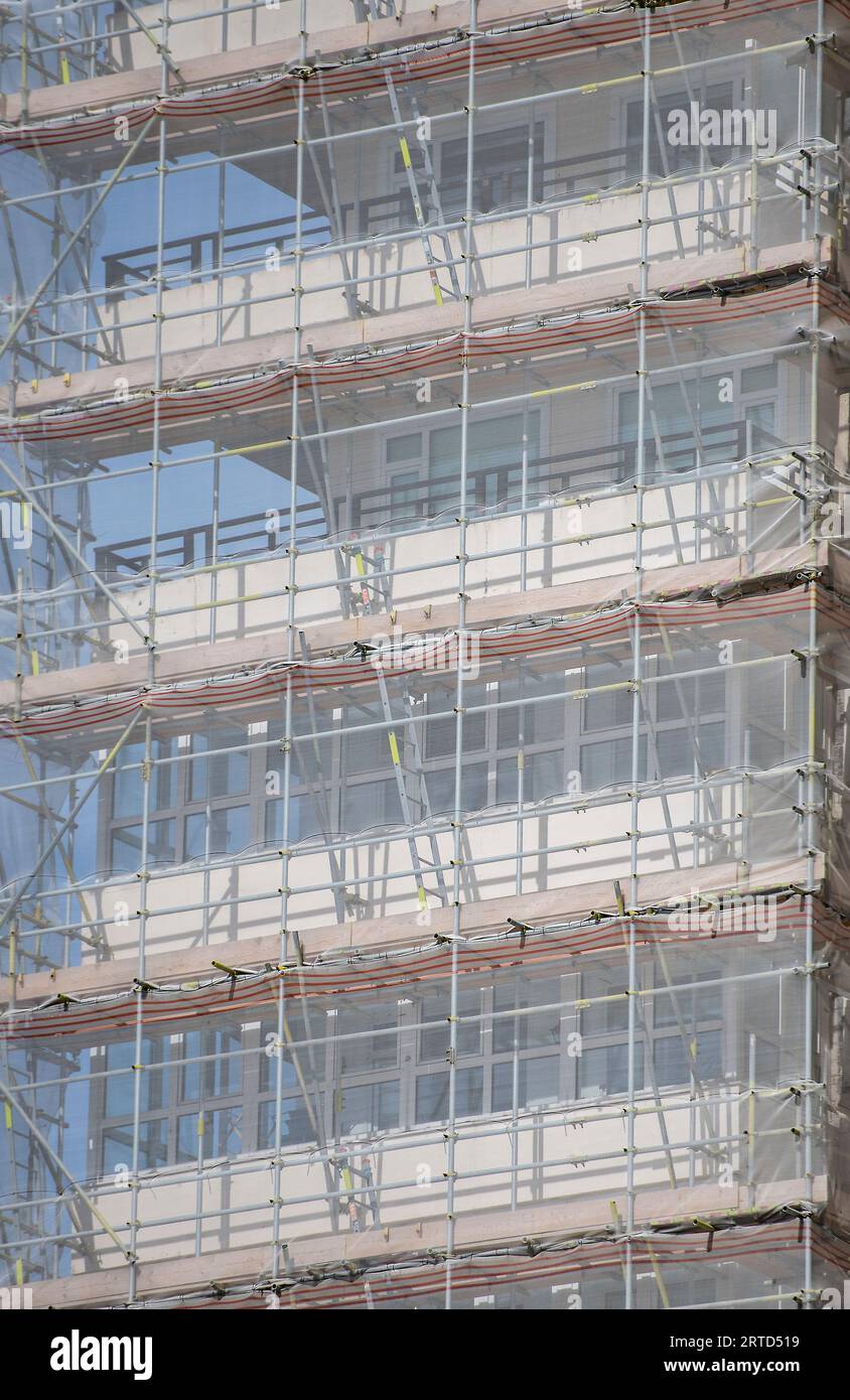 close-up of modern builders scaffolding on the side of a high rise building rows and lines forming a pattern suitable for background or backdrop. Stock Photo